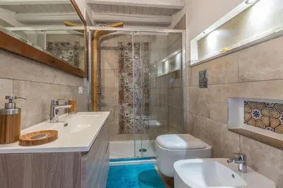 a bathroom with a toilet and a sink and a shower at Gò Gò House 2 Casa Aprile in Palermo