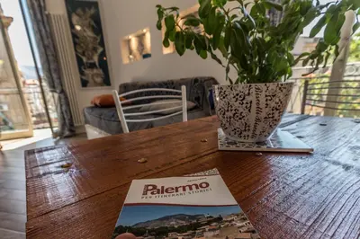 a table with a potted plant and a book on it at Gò Gò House 2 Casa Aprile in Palermo