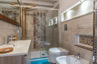 a bathroom with a shower and a toilet and a sink at Gò Gò House 2 Casa Aprile in Palermo