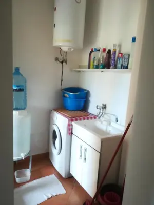 a small bathroom with a washing machine and a sink at Villa Mimmo in Lascari