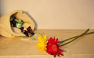 a bouquet of flowers sitting on the floor next to a towel at Hotel Columbia in Palermo