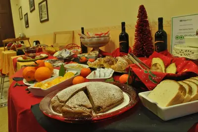 a table with bread and other food and wine bottles at Hotel Columbia in Palermo