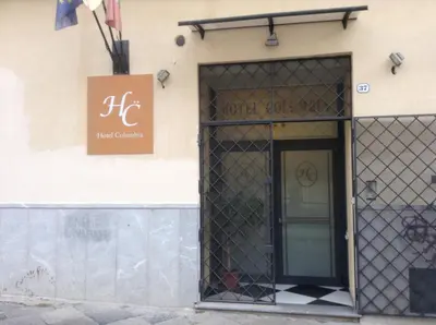 a building with a door and a sign on it at Hotel Columbia in Palermo