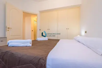 a large bed with two towels on top of it at Villa Nettuno con piscina privata in Campofelice di Roccella