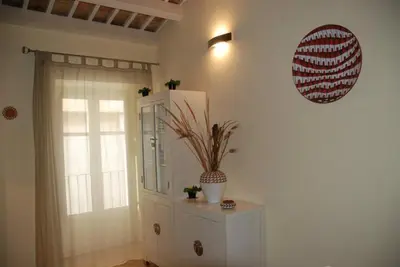 a room with a white cabinet and a plant on the wall at Locanda Re Ruggero in Monreale
