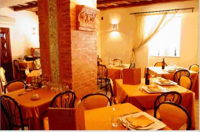a restaurant with tables and chairs in a room at Locanda Re Ruggero in Monreale