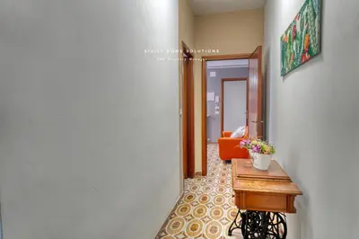 a hallway with a table with a potted plant on it at Casa dei Coralli Panoramic Sea View Centro Storico By Sicily Home Solutions in Castellammare del Golfo