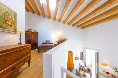 a living room with white walls and a wooden ceiling at Charming Apartment in the City Center by Wonderful Italy in Palermo
