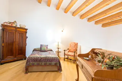 a bedroom with a bed and a couch and a chair at Charming Apartment in the City Center by Wonderful Italy in Palermo