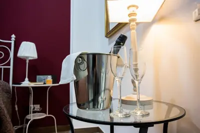 a table with a blender and two wine glasses at Casa Florio Appartamenti in Palermo