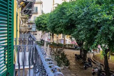 a view from a balcony of a street with trees at Kala Rooms in Palermo