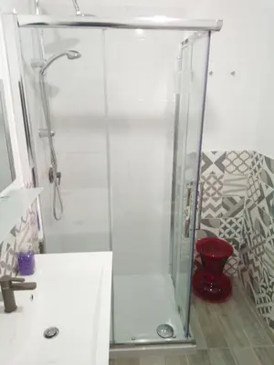 a shower with a glass door in a bathroom at Affittacamere Garibaldi in Alcamo
