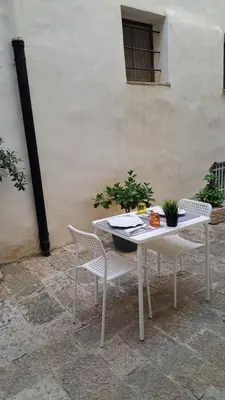 a white table and chairs on a patio at Affittacamere Garibaldi in Alcamo