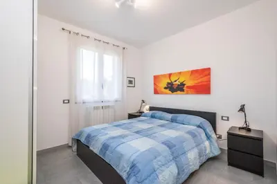 a white bedroom with a bed and a window at Villa Francesco...graziosa, moderna, confortevole! in Lascari