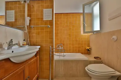 a bathroom with a sink and a toilet and a tub at Ai Bastioni del Massimo in Palermo