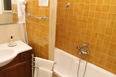 a bathroom with a shower and a tub and a sink at Ai Bastioni del Massimo in Palermo