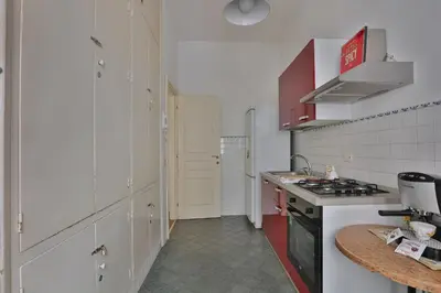 a kitchen with white cabinets and a stove top oven at Ai Bastioni del Massimo in Palermo