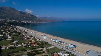 an aerial view of a beach next to the water at Riva Sea Apartments in Castellammare del Golfo