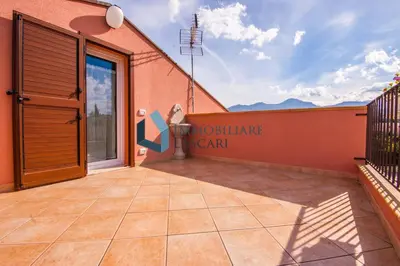 a patio with a large glass door on a building at Villa Ricky, a pochi passi dal mare in Lascari