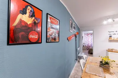 a dining room with coca cola posters on the wall at Arianna's House Historical Market in Palermo