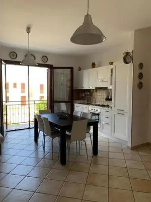 a kitchen with a dining room table and chairs at Blu Terrace in San Vito lo Capo