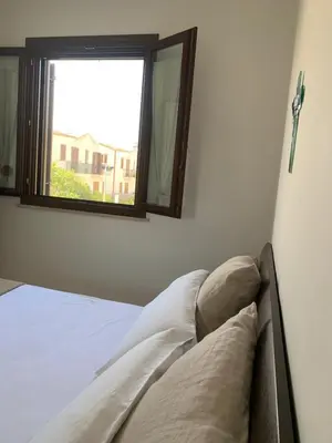 a bed in a room with a window at Blu Terrace in San Vito lo Capo