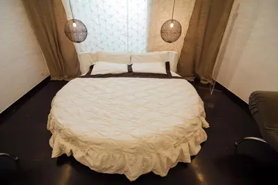 a bedroom with a white bed with two pendant lights at Atmosfere Puniche b&b in Palermo