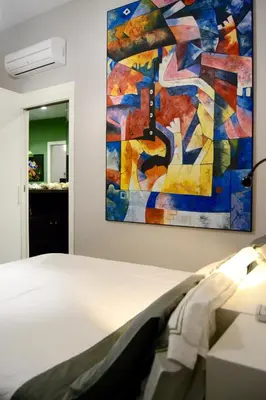 a bedroom with a painting on the wall at Atmosfere Puniche b&b in Palermo