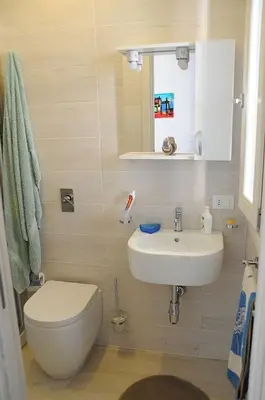 a bathroom with a toilet and a sink at Appartamento Irma Dario in San Vito lo Capo