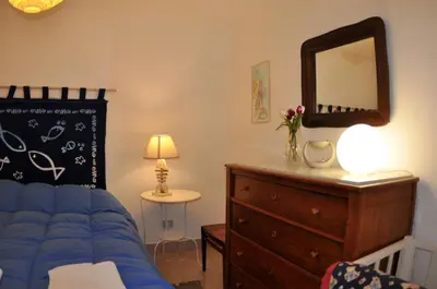 a bedroom with a bed and a dresser and a mirror at Casa Frida in Palermo