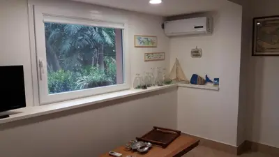a living room with a window and a wooden table at Casa Frida in Palermo