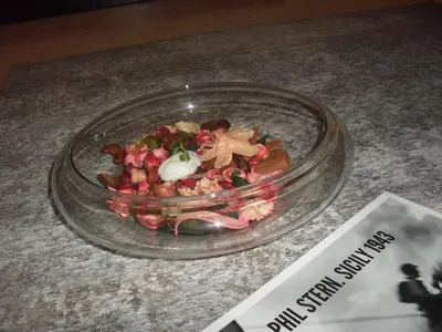 a salad in a glass bowl on a table at Ai quattro canti di città, appartamento in centro in Palermo