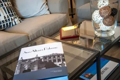 a glass coffee table with a book on it at Ci'Cala House in Palermo