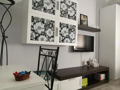 a living room with a desk and a tv in it at B&B A casa dell'artista in Casteldaccia