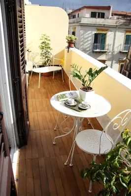 a balcony with a table and chairs on a balcony at B&B Vivere Palermo in Palermo