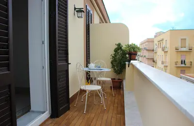 a balcony with a table and chairs on a building at B&B Vivere Palermo in Palermo