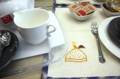a table with a cup and a fork and a napkin at B&B Vivere Palermo in Palermo