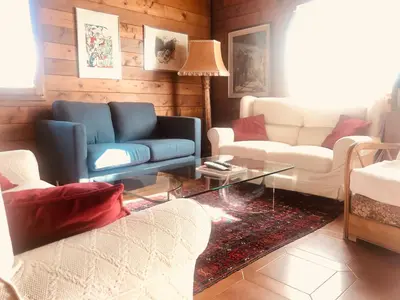 a living room with two couches and a table at Villa Rosemada, Mondello in Palermo