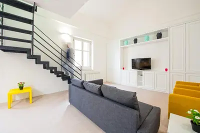 a living room with a staircase and a couch at Loft 18 by Wonderful Italy in Palermo