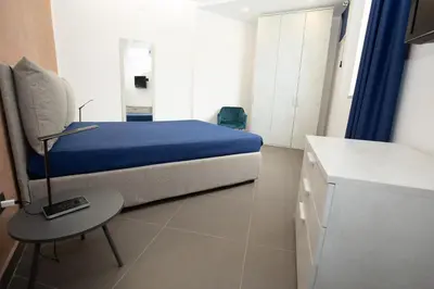 a bedroom with a bed and a table in it at Hotel Sporting Club in Altavilla Milicia
