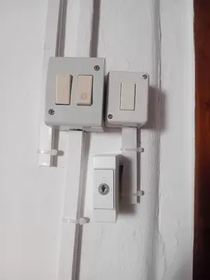 a wall with two white switches on a wall at Room holiday 