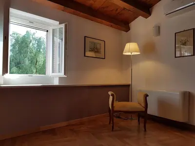 a room with a chair and a window at Boutique House Montevergini in Palermo