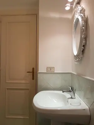 a bathroom with a white sink and a mirror at Boutique House Montevergini in Palermo