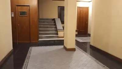 a hallway with two doors and stairs in a building at se vi pare in Palermo