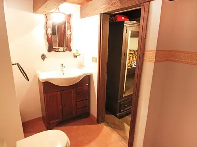 a bathroom with a sink and a toilet and a mirror at Orologio del Massimo in Palermo
