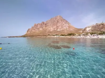 a view of a beach with a mountain in the background at Le Case di Palma - Viola in San Vito lo Capo