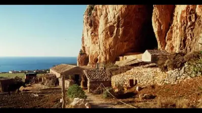 a group of buildings on the side of a mountain at Le Case di Palma - Viola in San Vito lo Capo