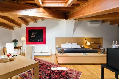 a bedroom with a bed and a living room at Palazzo Brunaccini Boutique Hotel in Palermo