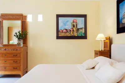 a bedroom with a bed and a dresser and a mirror at Palazzo Brunaccini Boutique Hotel in Palermo