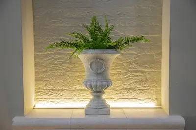 a plant in a vase sitting in a window at House Orlando in Sferracavallo